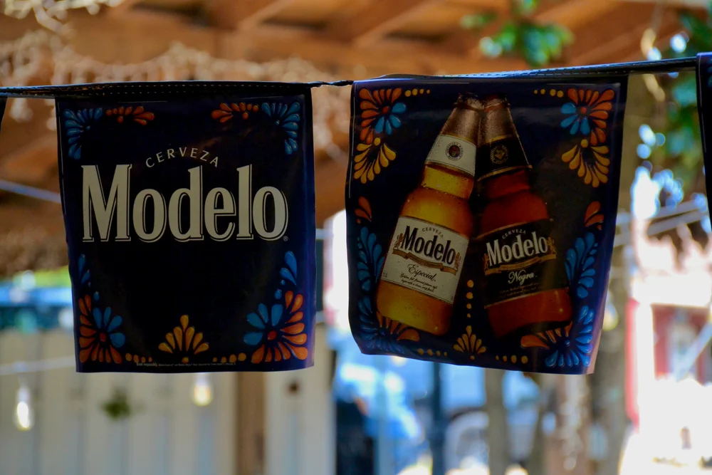 Colorful Modelo pennants hanging in the warm restaurant interior