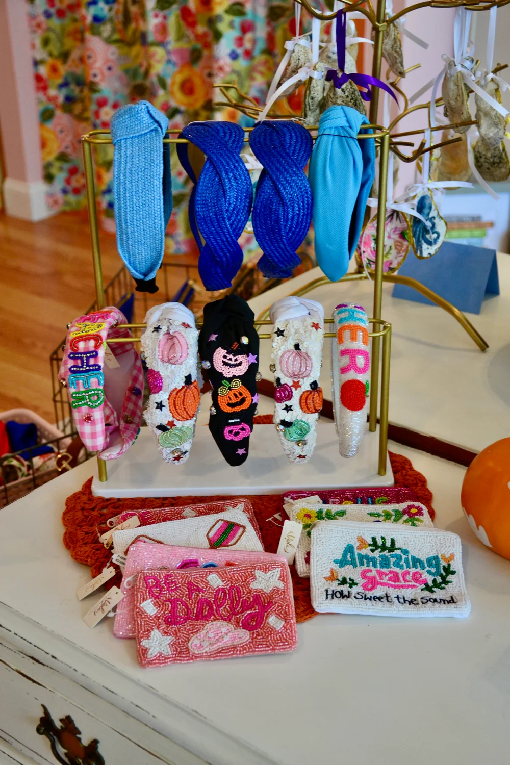 A shop display of bright headbands and embroidered beaded purses
